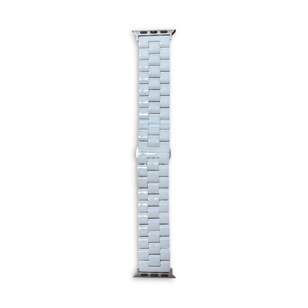 Anhem white ceramic apple watch band laid flat on surface shiny white