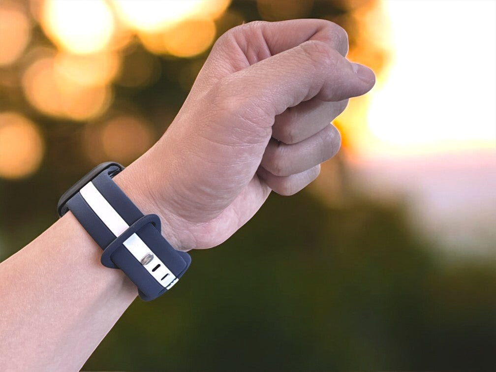anhem pepi silicone apple watch sport band in blue and white on wrist during sunset