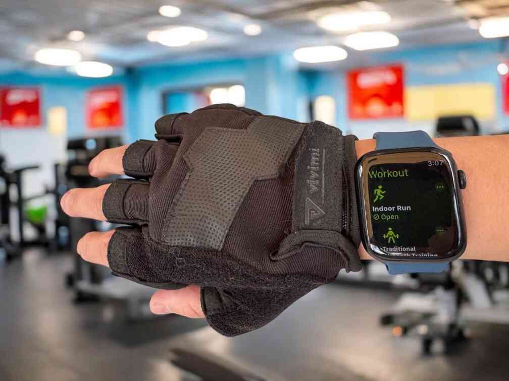 anhem active silicone apple watch band in blue inside a gym on wrist