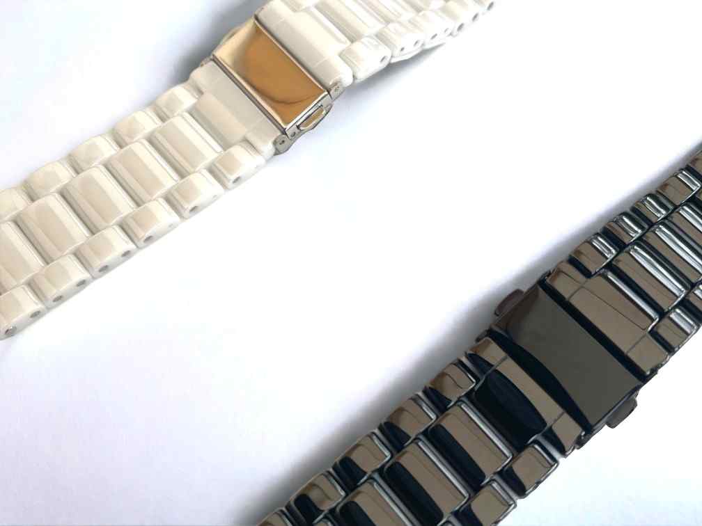 Close-up of a black and a white Classic Ceramic Band by Anhem, highlighting their elegant finish and secure clasp. Enhance your Apple Watch experience with these Ceramic Apple Watch Bands.