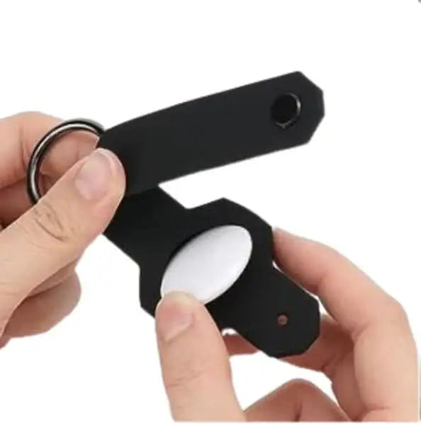 Close-up of Anhem's Smart Key Case Holder & Organizer for Tag being held, showcasing the easy attachment feature for Apple AirTag, the perfect AirTag Keychain Holder.  Smart Key Case Holder & Organizer for Tag  anhem.myshopify.com