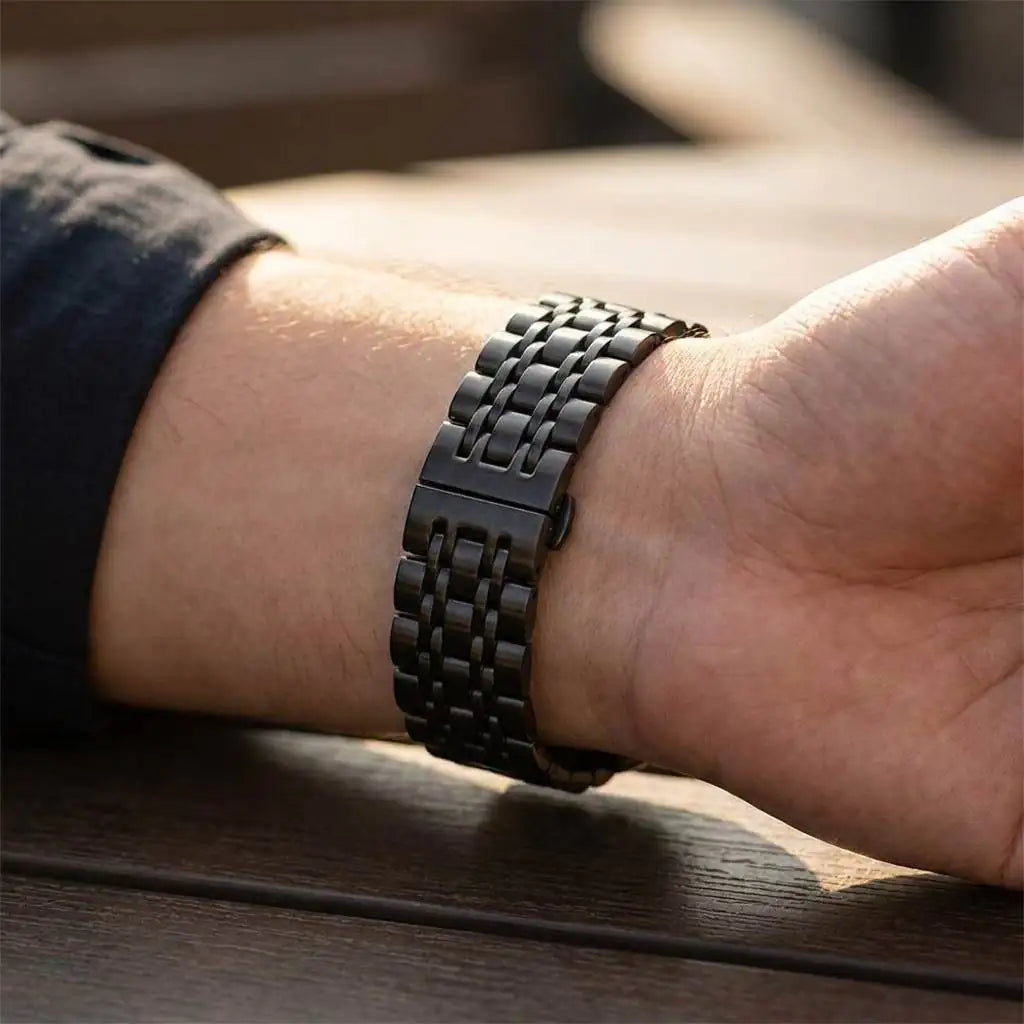 Anhem Allure Steel Strap in black stainless steel with a triple-link design and butterfly clasp worn on a wrist.