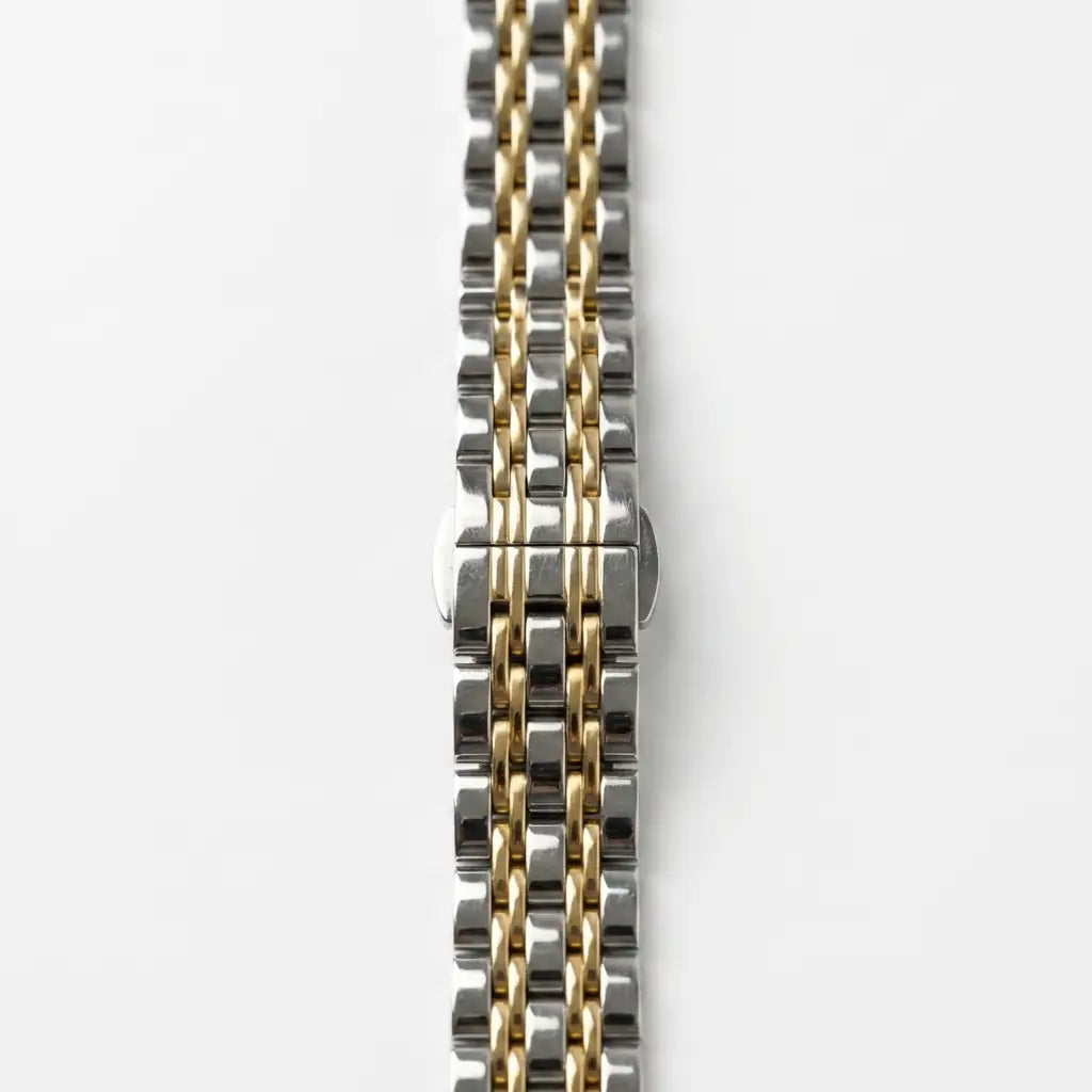 Anhem Glam Steel two-tone silver and gold slim link Apple Watch band on a white background.