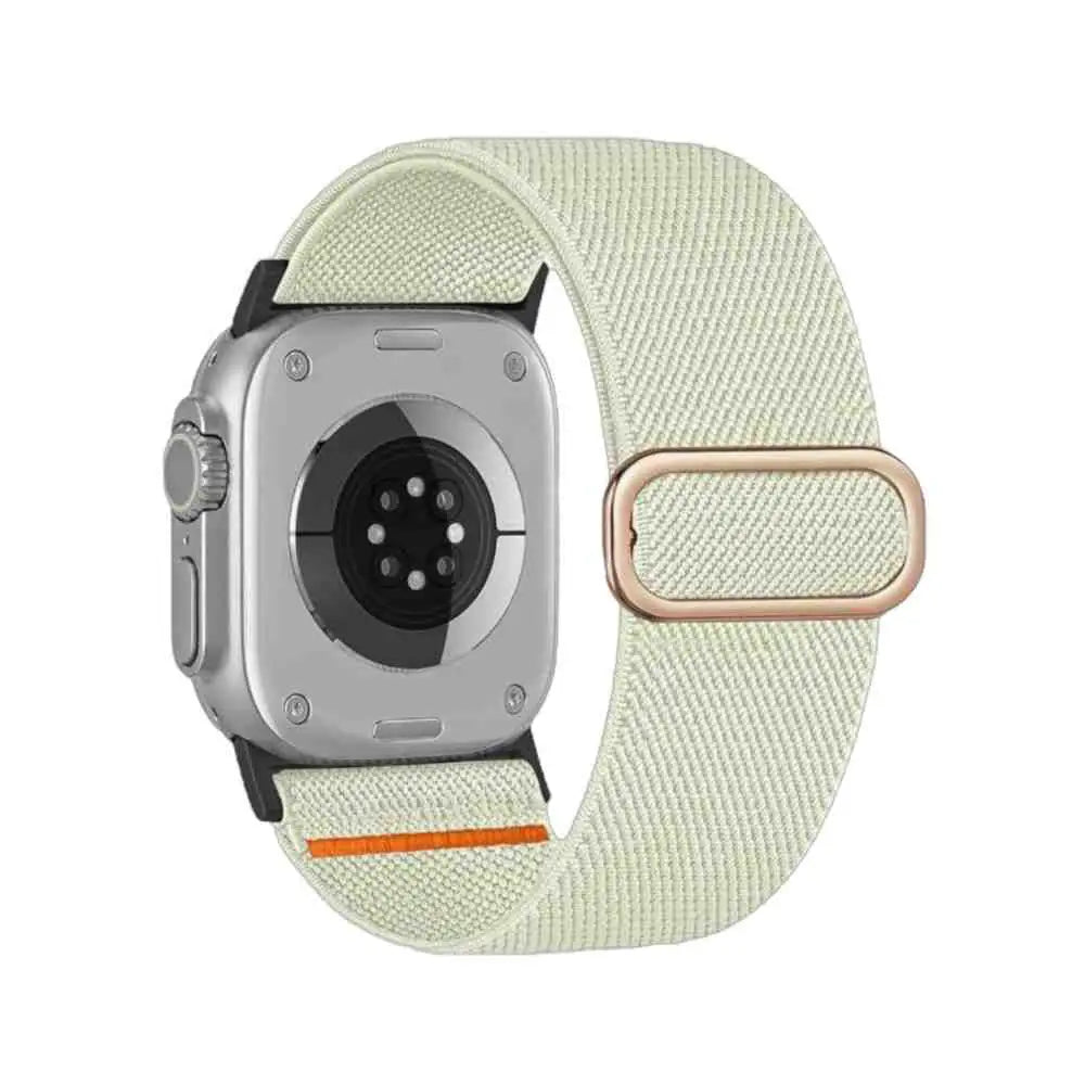 Anhem Ultra Nylon elastic Apple Watch band in cream with a rose gold metal buckle and orange accent detail.