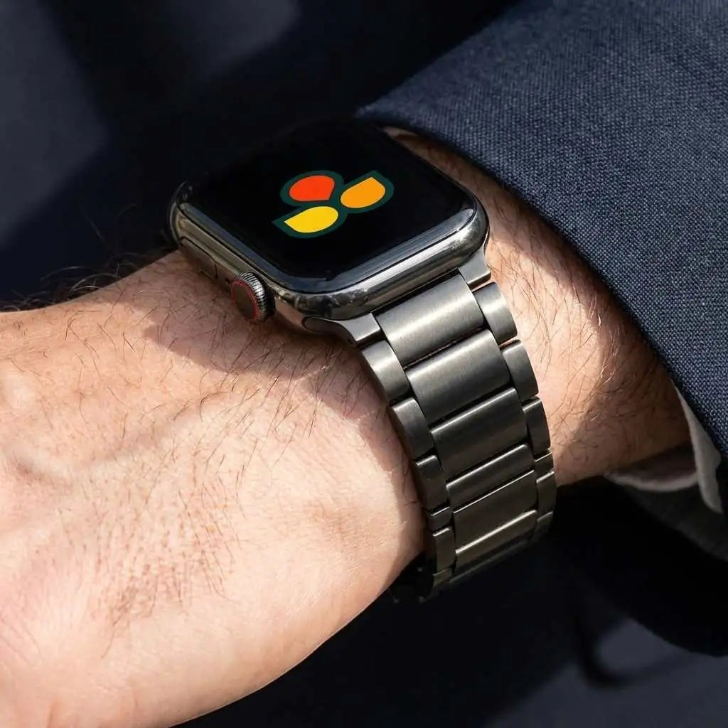 Anhem Ultra Titanium Strap for Apple Watch, a sleek dark grey metal band with a brushed finish, designed for everyday wear.