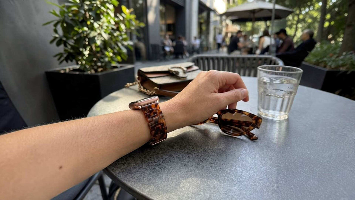 woman wearing anhem amber resin apple watch band with matching tortoise shell sunglasses